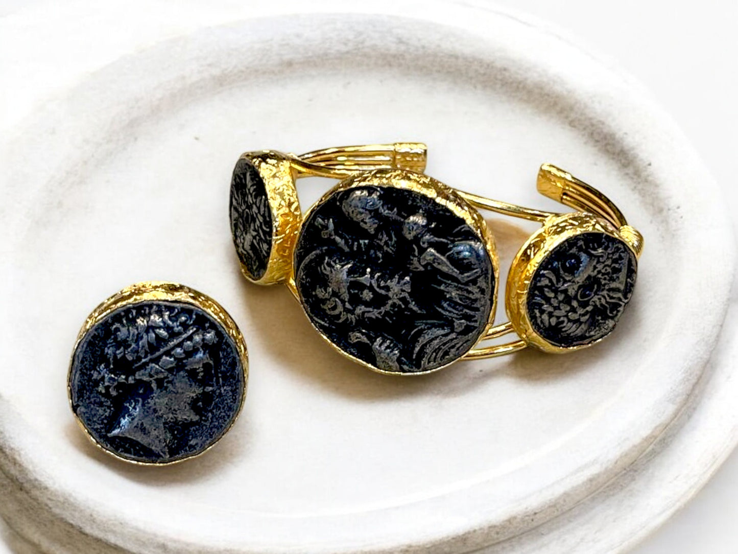 a white plate topped with two cufflinks and a coin