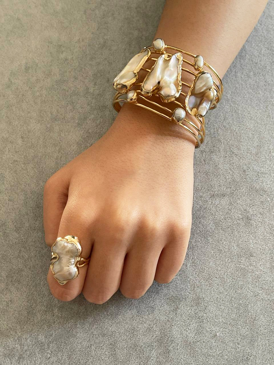 a woman's hand with a ring and a bracelet