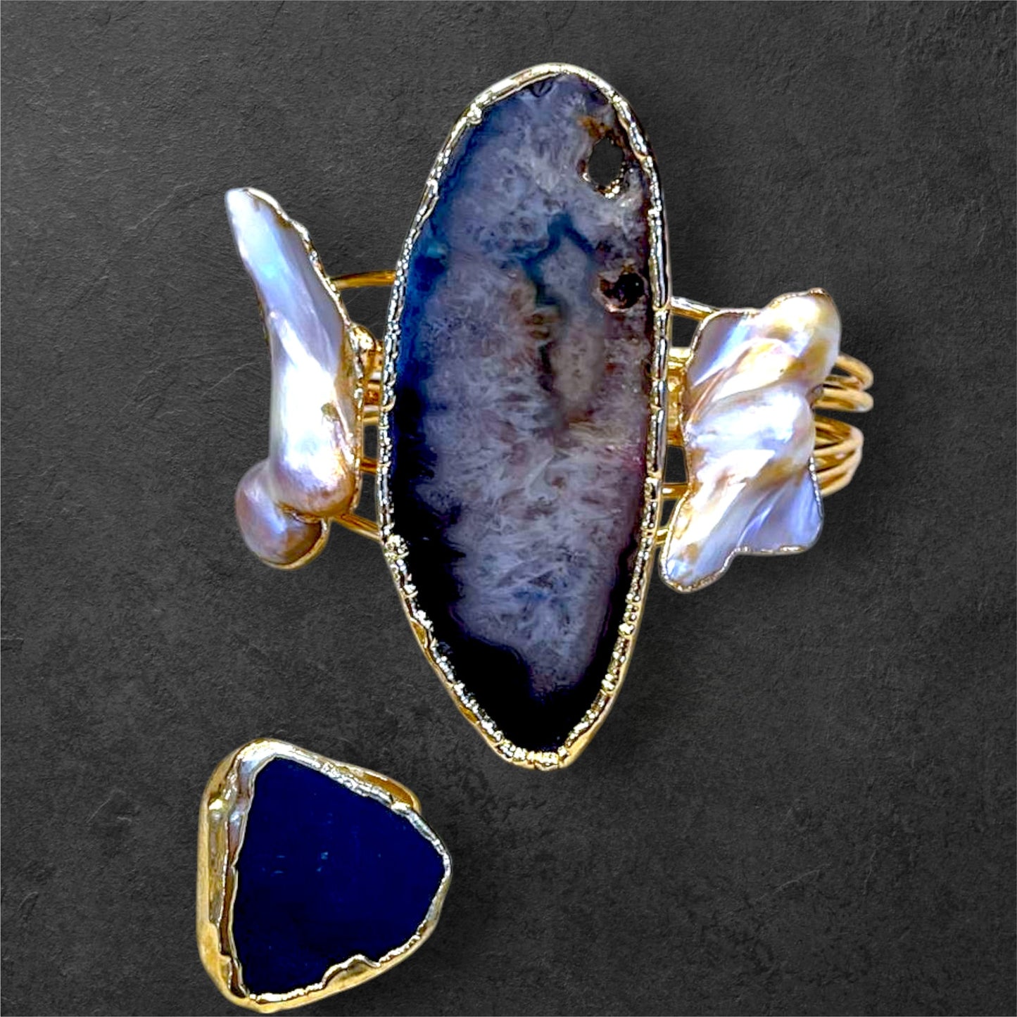 a gold ring with a blue agate and a white agate