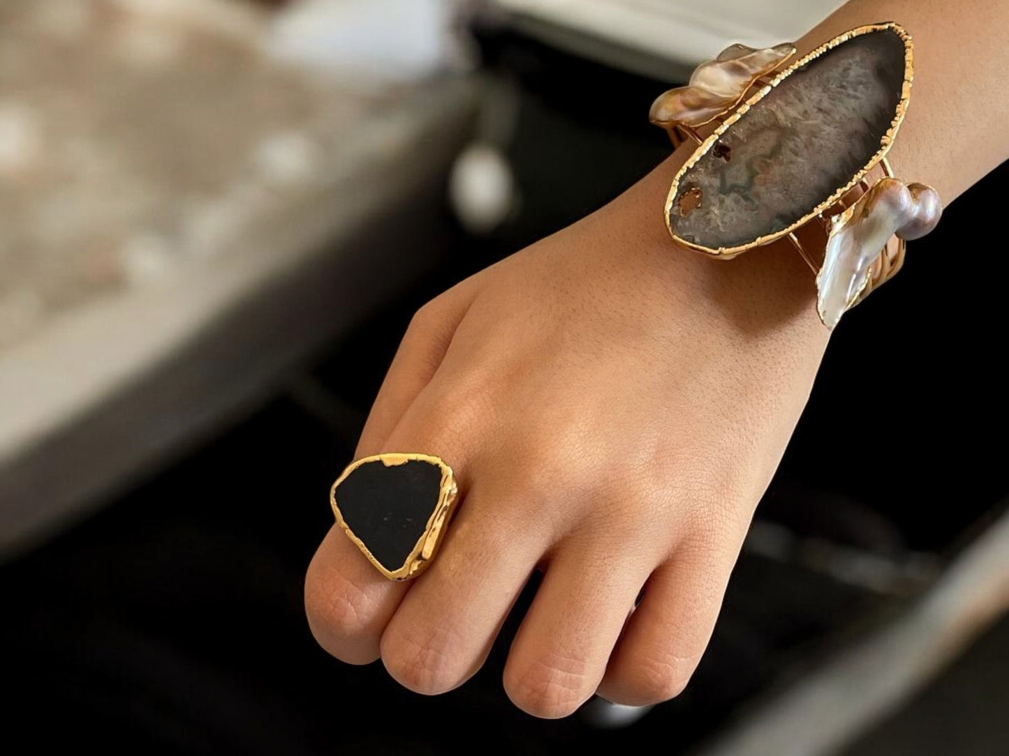 a close up of a person's hand with a ring on it