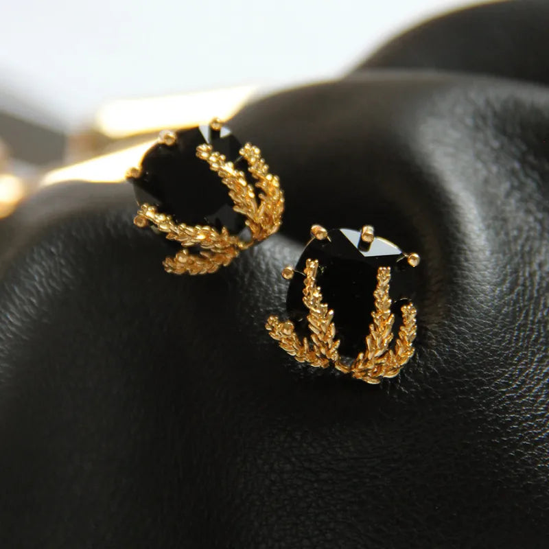 Elegant Black Glass Stud Earrings with Metallic Gold Accents