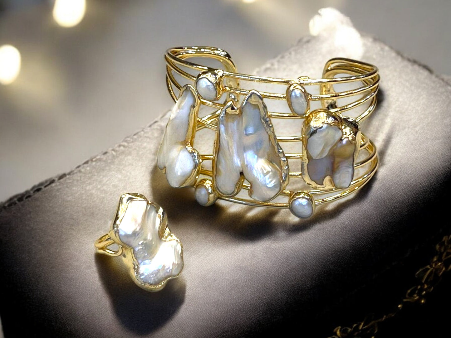a close up of a brooch with pearls on it