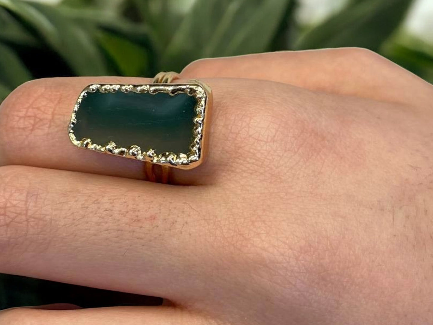 a close up of a person's hand with a ring on it