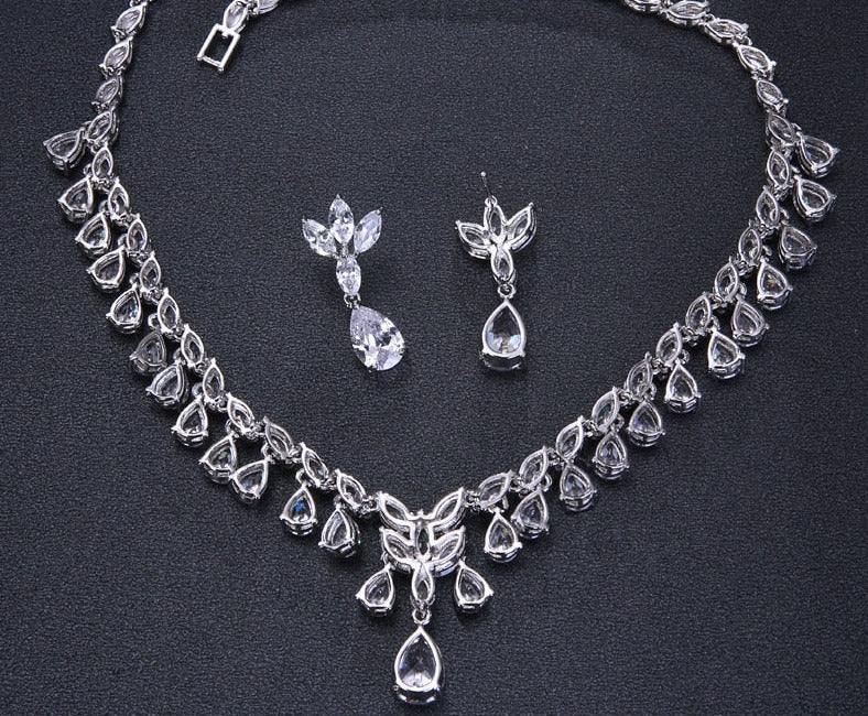 Cubic Zirconia Drop Necklace and Earrings Set with Plant-Inspired Desi
 
 Make a statement at any occasion with this trendy and elegant jewelry set. Crafted from high-quality copper and adorned with sparkling cubic zirconia, this set iGlam DuchessGlam DuchessCubic Zirconia Drop Necklace